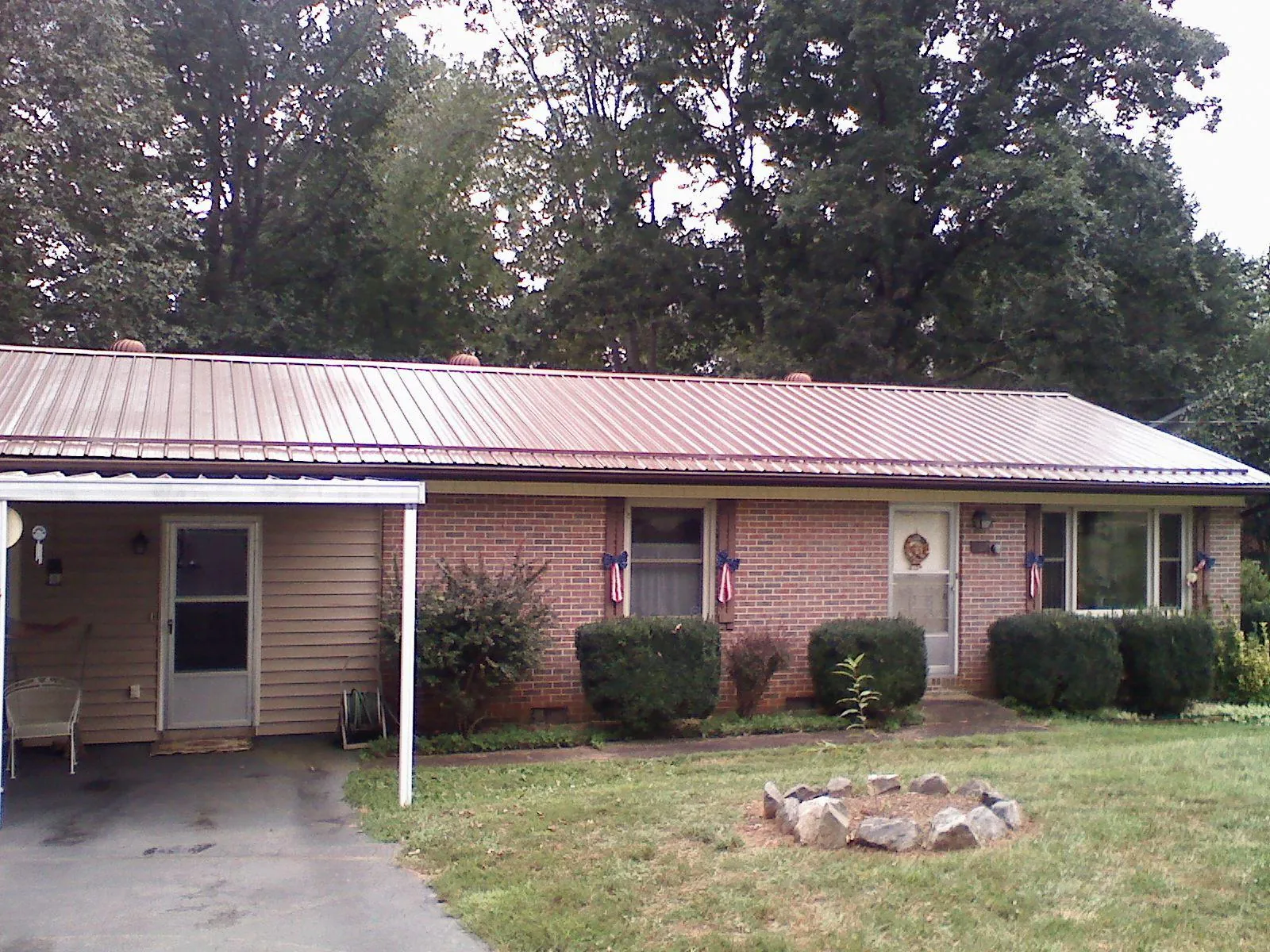 Bronze metal roof and carport on a brick ranch home — Roof Repair work by our crew in Fairfield